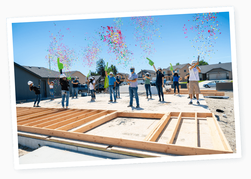 image of volunteers celebrating building a holme